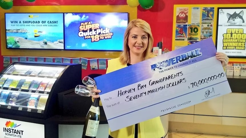 Elizabeth Caruso holding US$1,000,000 check
